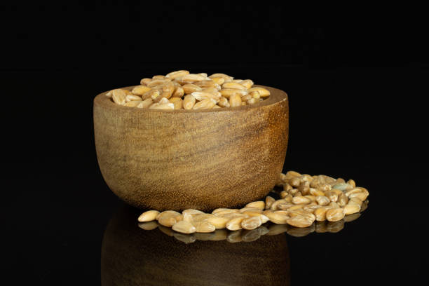 istock Dinkel wheat grain isolated on black glass 1163714765