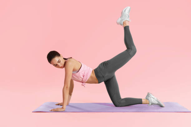 istock Fitness woman doing hip workout exercising on yoga mat at studio 1163715629