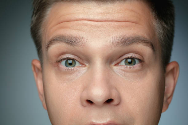 istock Close-up portrait of young man isolated on grey studio background 1163715778