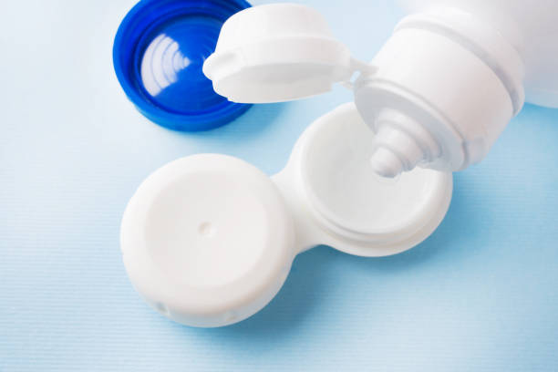 istock Contact lenses, solution bottle and lens storage container. Close up. Selective focus. 1163716139