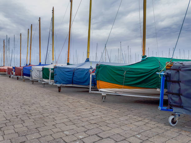 Row of multi colored maritime signal flags hanging. Decoration on top of fishing boat , Virgen del Carmen traditional festival, Burela harbor, Lugo province, Galicia, Spain.