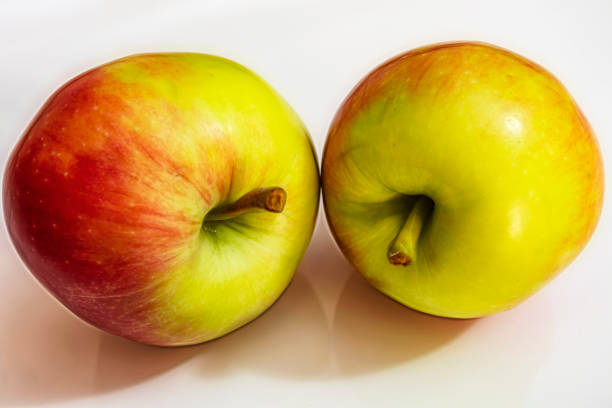istock close up green and red apple on white background 1163718624