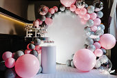 Delicious wedding reception. Birthday Cake on a background balloons party decor. Copy space. Celebration concept. Trendy Cake. Candy bar. Table with sweets, candies, dessert.