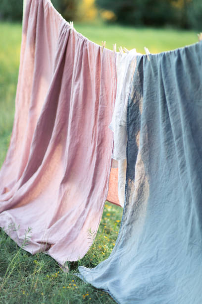 istock Clean bed sheet hanging on clothesline. 1163718831
