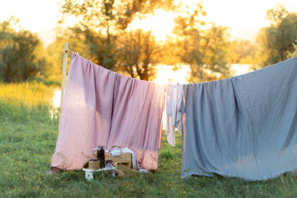 istock Clean bed sheet hanging on clothesline. 1163718835