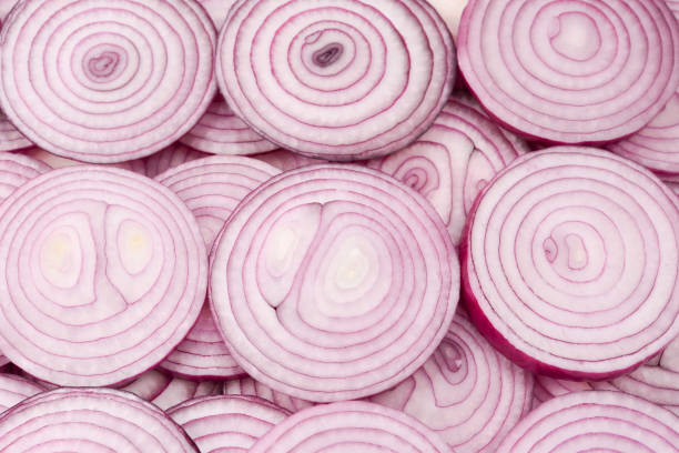 istock Onion slices as a background. Top view. 1163719602