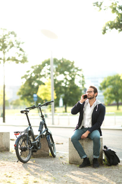 istock Electric bike commuter talking with smart phone during lunch break 1163720855