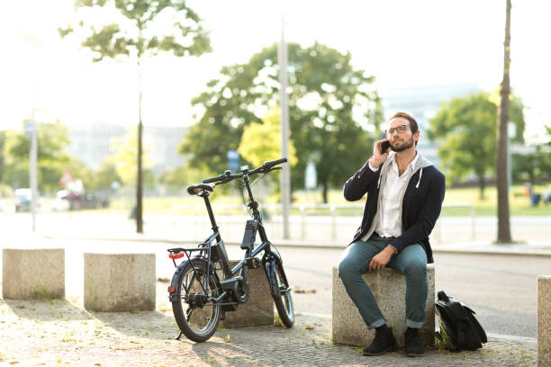 istock Electric bike commuter talking with smart phone during lunch break 1163720876