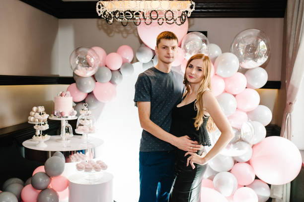 istock Hugging and enjoying couple, spending time together while celebrating Saint Valentine's Day on the background air balloons, party of birthday. Happy joyful family. Love. 1163721623