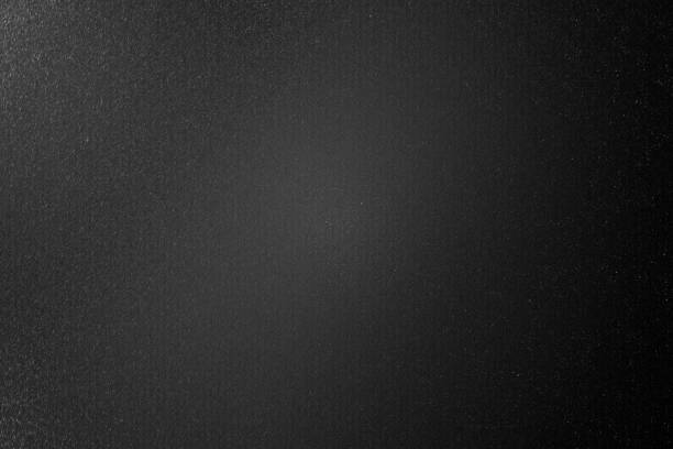 istock Dirty brushed black metal wall in dark room, abstract texture background 1163721792