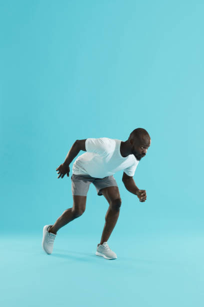 istock Sport. Man runner in running start pose, preparing to run 1163723522