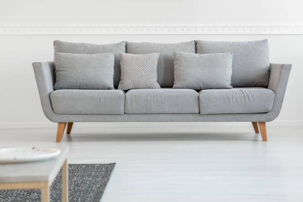 istock Simple grey couch in bright scandinavian living room interior 1163725951
