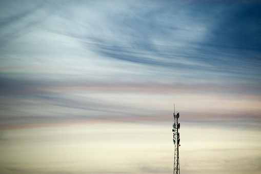 Telecommunications tower, telephone and internet antennas, afternoon as background, dusk and cell tower silhouette