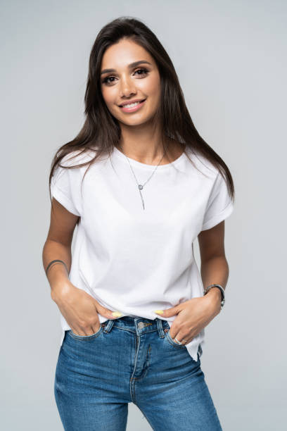 istock Pretty smiling joyfully female with fair hair, dressed casually, looking with satisfaction at camera, being happy. Studio shot of good-looking beautiful woman isolated against blank studio wall. 1163732321