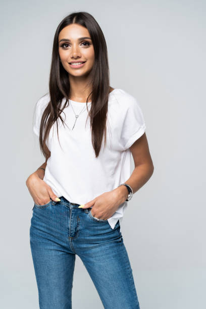 istock Pretty smiling joyfully female with fair hair, dressed casually, looking with satisfaction at camera, being happy. Studio shot of good-looking beautiful woman isolated against blank studio wall. 1163732327