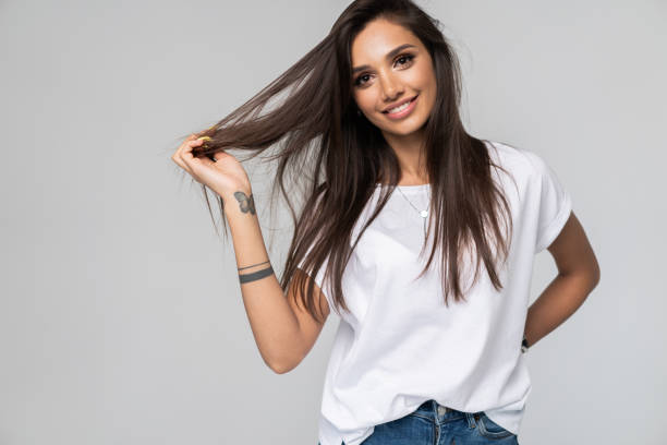 istock Pretty smiling joyfully female with fair hair, dressed casually, looking with satisfaction at camera, being happy. Studio shot of good-looking beautiful woman isolated against blank studio wall. 1163732330