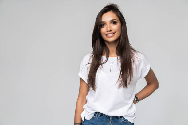 istock Pretty smiling joyfully female with fair hair, dressed casually, looking with satisfaction at camera, being happy. Studio shot of good-looking beautiful woman isolated against blank studio wall. 1163732331