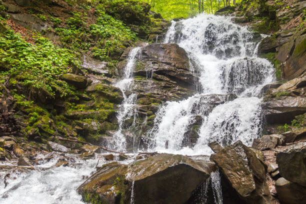 istock Wonderlust waterfall at the mountains during springtime. Background of nature 1163733491