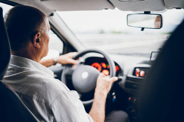 istock Senior man driving car 1163733518
