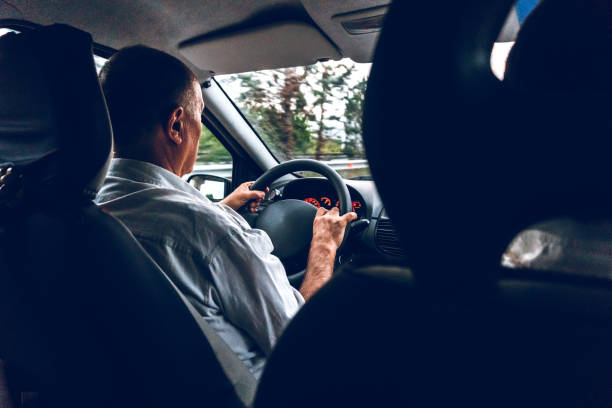 istock Senior man driving car 1163733613