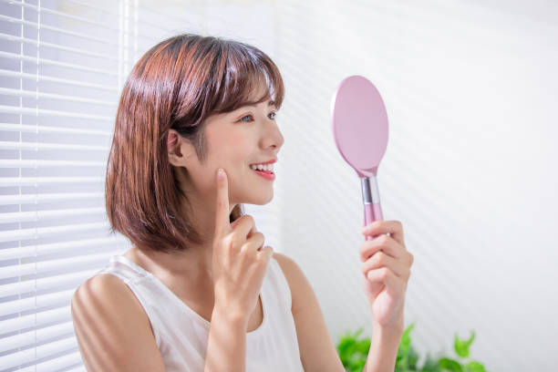 istock Young asian woman look mirror 1163733837