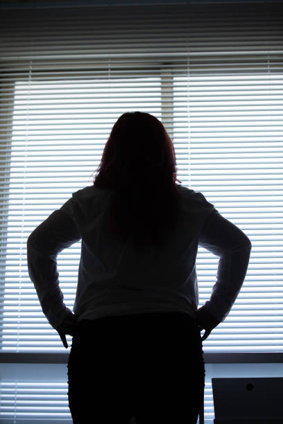 istock woman looking out of office 1163734454