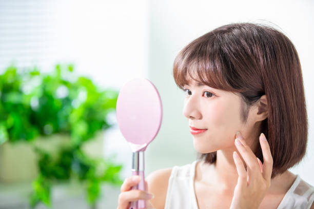 istock Young asian woman look mirror 1163735016