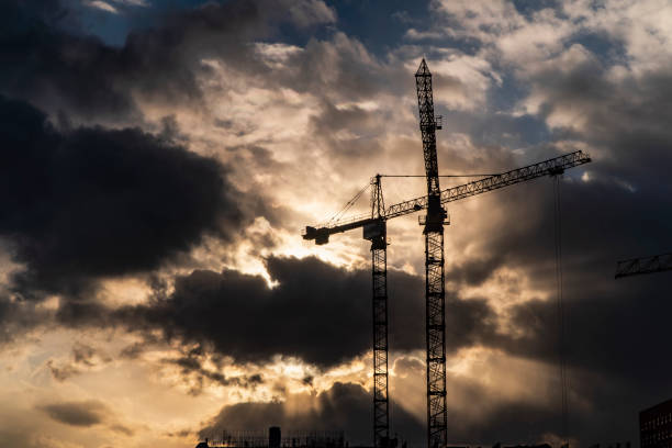 istock The work of construction cranes on the background of flying clouds 1163738420