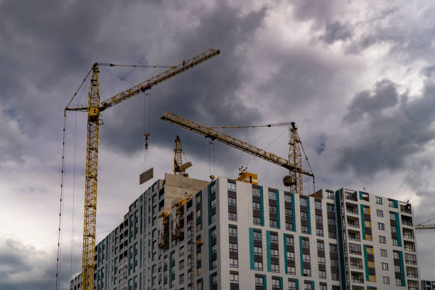 istock The work of construction cranes on the background of flying clouds 1163738424