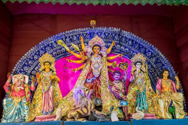 Photo of Idols of Hindu Goddess Maa Durga with her childrens in a pandal beautifully decorated during the Durga Puja festival.