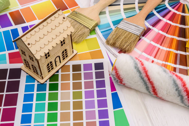 istock Wooden house model and roller on color palette 1163739736