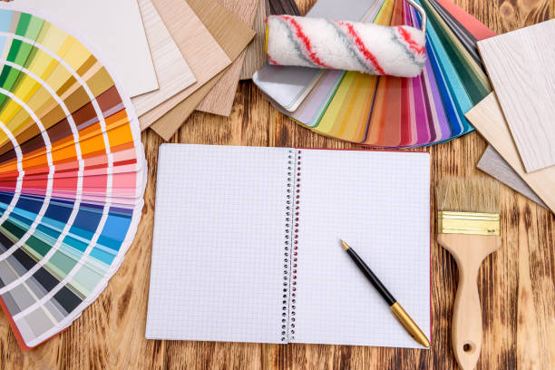 istock Open notepad on table with color and wood swatch 1163739823