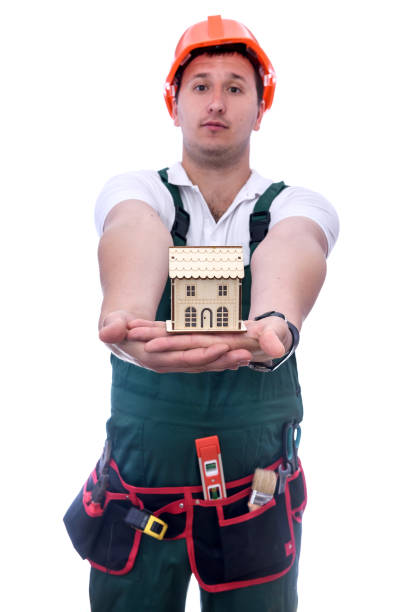 istock Man holding wooden house model on palm 1163740764