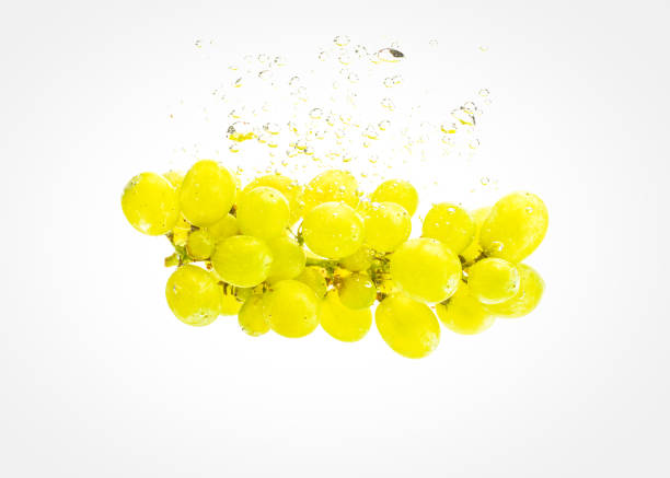 istock Bunch of green grapes sinking into crystal clear water. 1163741450