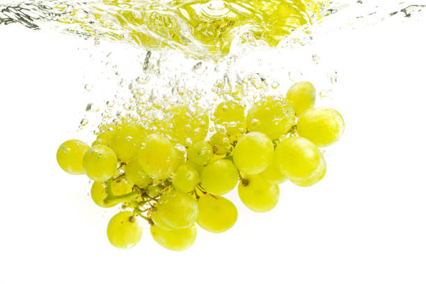 istock Bunch of green grapes sinking into crystal clear water. 1163741492