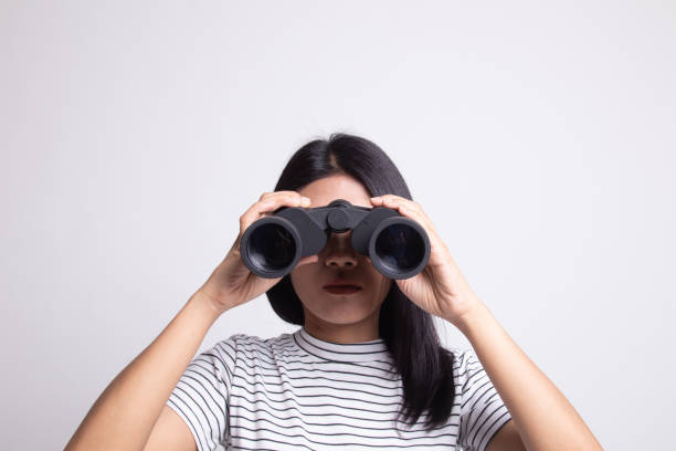 istock Young Asian woman with binoculars. 1163741826