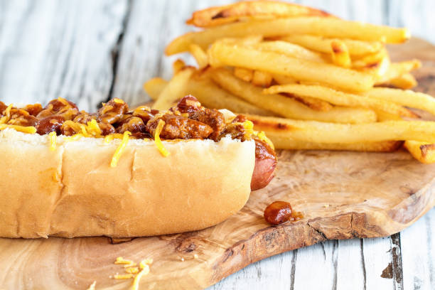 istock Hot dog with chili, cheddar cheese and mustard 1163743539