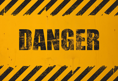 Yellow background with black grunge danger sign