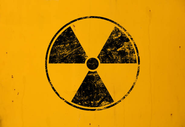 istock Black radioactive sign over yellow background 1163744905