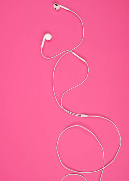 istock earphones with a white cable on a pink background 1163745464