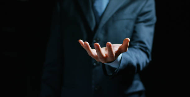 istock a businessman in a suit holding his hands in position to implement the graphic. 1163746702