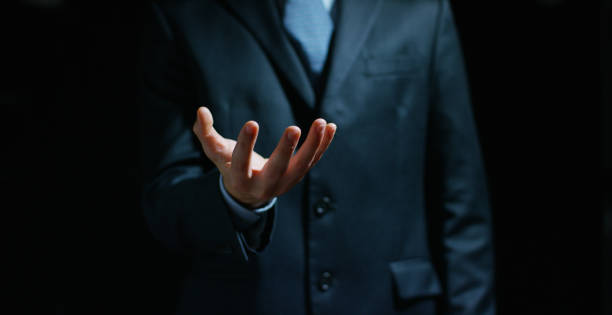 istock a businessman in a suit holding his hands in position to implement the graphic. 1163746982