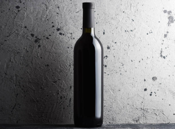 istock Bottle of wine on grey concrete background copy space 1163747404