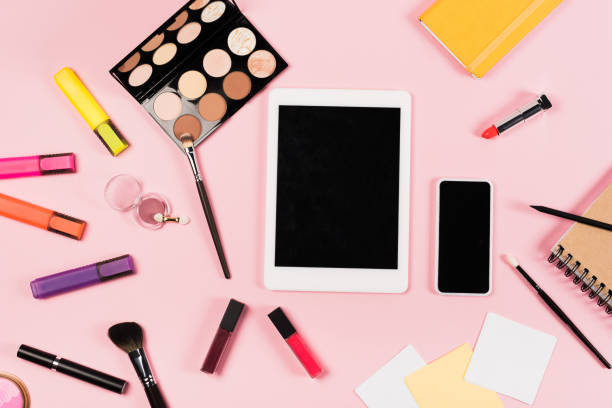 istock top view of digital tablet and smartphone with blank screen, notebooks and decorative cosmetics on pink 1163756063