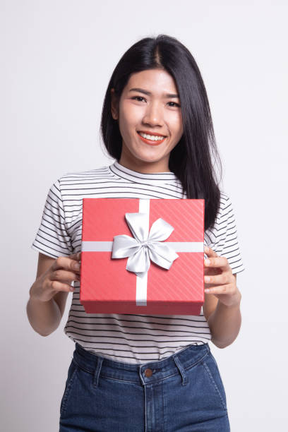 istock Young Asian woman with a gift box. 1163756317