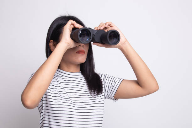 istock Young Asian woman with binoculars. 1163756380