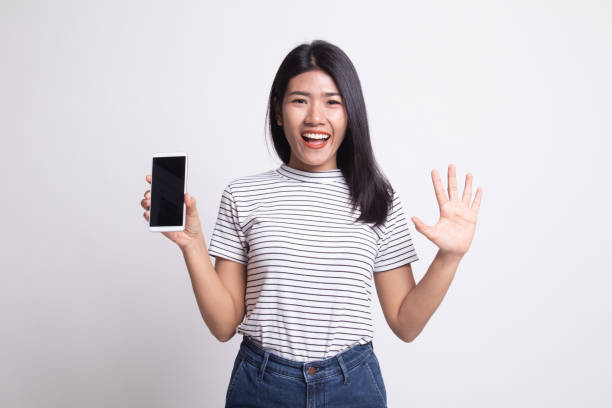 istock Young Asian woman with mobile phone. 1163756765