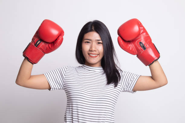 istock Young Asian woman with red boxing gloves. 1163756873