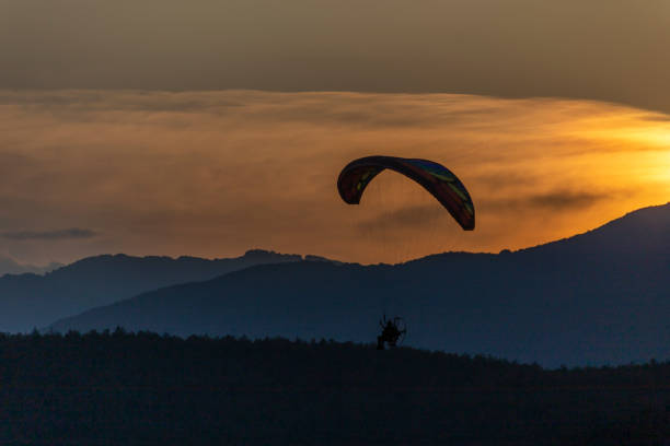 istock Paragliding at sunset with amazing view 1163759885