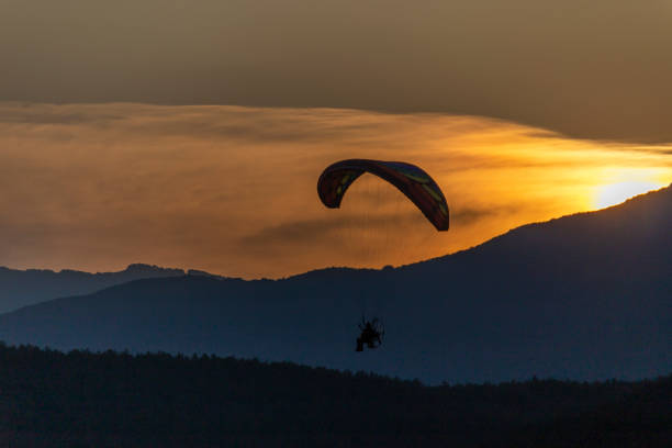 istock Paragliding at sunset with amazing view 1163759902